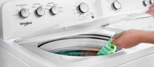 Placeholder image: close-up of a washing machine drum and bearing area causing loud noise