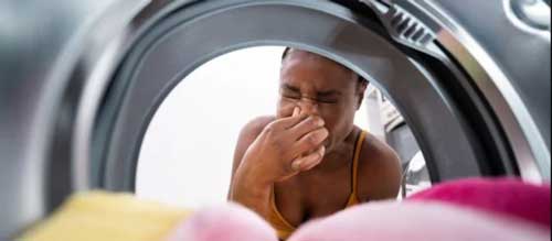 Placeholder image: mould and residue build-up inside a washing machine door seal causing bad smells
