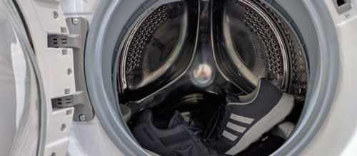 Placeholder image: technician inspecting a washing machine drum that will not spin